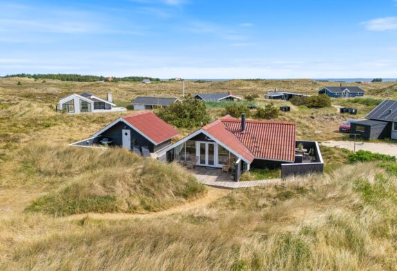 Gemütliches Ferienhaus umgeben von Dünen mit Kaminofen